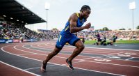 Professional Male Sprinter Explosively Starting Race on Outdoor Track Stadium